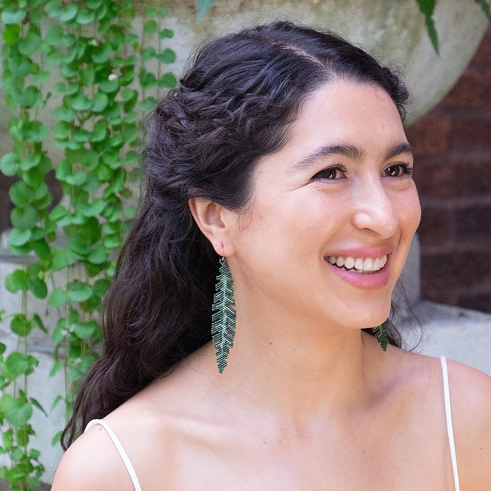 Colombian model wearing Banana Leaf Earrings made of glass beads